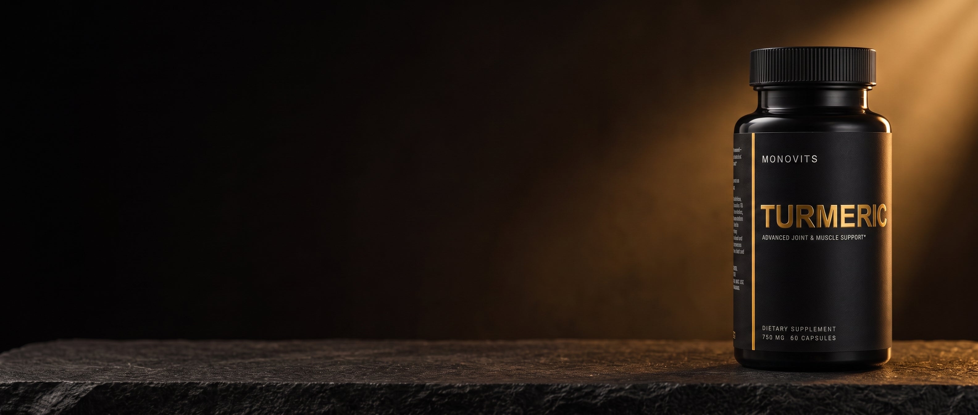 A Monovits Turmeric bottle at the edge of a dark stone stage, lit by a shaft of warm amber light.